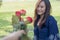 A man giving red rose flowers to asian girlfriend on Valentine`s day