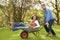 Man Giving Woman Ride In Wheelbarrow