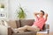 Man in glasses relaxing on sofa at home