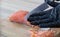 Man in gloves cuts fish into slices.Piece of fresh raw salmon on  board