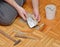 Man is Gluing Wooden Floor