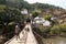 Man and Goats Crossing Bridge