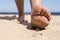 Man goes on the beach and the risk of stepping on a splinter of broken bottle glass