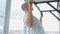 Man goes in for sports doing pull-up exercises on horizontal bar at his home