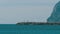 Man goes to the Lighthouse, around it Flies a Flock of Seagulls on the Beach. Gibraltar. Spain.