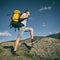 Man goes uphill with a backpack on his back