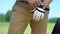 Man golf player wearing on hand special leather glove, professional equipment