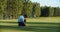 A man golfer in a cap plays on the field. Time for golf