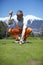 Man golfer putting his golf ball on the green