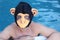 Man with gorilla mask in swimming pool