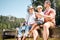 Man, grandparent and fishing with son in summer on deck for holiday with bonding for weekend. Rod, grandpa and