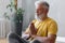 man with gray hair meditates and does breathing exercises. sports fitness and physical exercises for the elderly