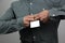 Man in a gray shirt holds a closed iron lock in his hands, trying to break it, concept of difficulties, close-up