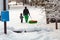 The man in green pants with their son spend the weekend in the woods go for a drive on the hill and pull the sleds behind them in