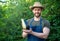 man greengrocer presenting eggplant and vegetable marrow