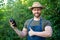 man greengrocer in straw hat with eggplant vegetable. thumb up