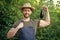 man greengrocer in straw hat with healthy eggplant vegetable