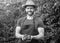 man greengrocer in straw hat with tomato bunch. vegetarian