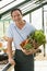 Man in greenhouse holding basket of vegetables