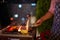 A man is grilling the food, vegetables and steaks on bbq on the patio at summer evening