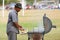 Man Grills Hamburgers For Youth Football Game