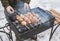 A man grills meat and mushrooms in winter. close-up. Winter picnic, outdoor recreation