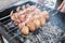 A man grills meat and mushrooms in winter. close-up. Winter picnic, outdoor recreation. defocus