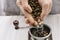 Man grinds coffee beans in a manual coffee grinder hands fall asleep grain in the coffee grinder