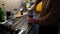 Man grinds coffee in a manual coffee grinder in the kitchen