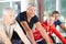 Man in group of seniors spinning in gym