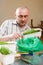 Man growing parsley and dill in pots