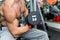 Man in gym holding dumbbell close up