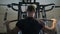Man in the gym trains the latissimus dorsi by the lat pulldown machine