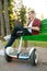 Man with gyroboard sitting on the bench in park
