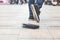 Man had lost leather wallet with money on the floor. Close-up of wallet lying on the sidewalk and feet of outgoing man