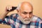 Man with hair clipper. Old bald man hair clipper, Mature baldness and hair loss concept.