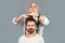 Man at the hairdresser getting a haircut. Hipster client in professional hairdressing salon. Professional barber styling