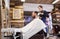 Man and hairdresser with mirror at barbershop