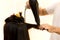 Man hairdresser using blower to dry customer hair
