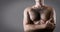 Man with hairy chest isolated on gray background for text.