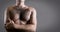 Man with hairy chest isolated on gray background for text.