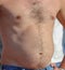 A man with a hairy chest and stomach as background