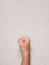 Man hairy hand clenched in fist against a gray background