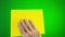 man hairy hand holds yellow napkin he wipes screen green chromakey background advertisement napkin is wiped then it is