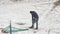 A man hammering a frozen ground with a jackhammer