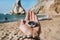 Man hand with compass symbolling adventure-seeking concept against Ursa beach, Sintra, Portugal