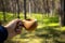 Man hand with cup of coffee. Camping wooden mug with a warm drink