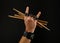 Man hand with drumsticks and devil horns on black