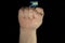 Man hand fist with Bahamian flag isolated on black