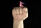 Man hand fist with Nepalese flag isolated on black